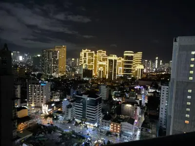 a city skyline at night with illuminated buildings at The Gramercy Residences Executive 1 bedroom with Balcony in Manila
