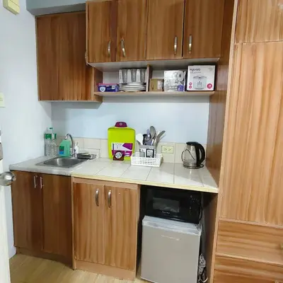 a small kitchen with a sink and a microwave at Fully Furnished Condo at Cyberzone-Filinvest in Manila