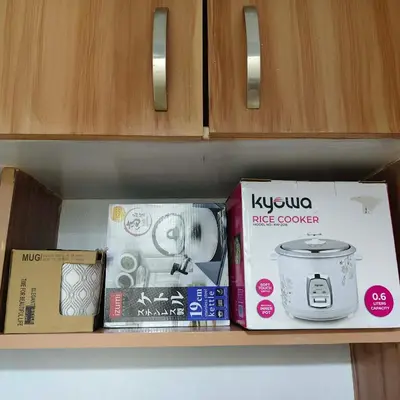 a shelf with a stove and boxes on it at Fully Furnished Condo at Cyberzone-Filinvest in Manila