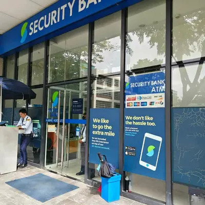 a man standing outside of a security bank building at Fully Furnished Condo at Cyberzone-Filinvest in Manila
