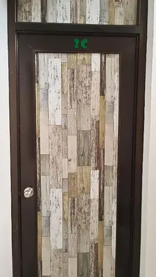 a brown door with a wall of squares on it at Makati 2C Suite Room in Manila
