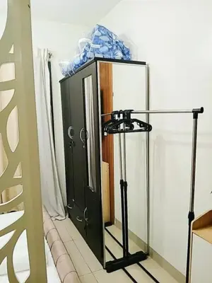 a green cabinet with a mirror in a room at Warm Retreat with Balcony at Shore 2 Residences in Manila