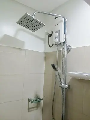 a shower in a bathroom next to a sink at Warm Retreat with Balcony at Shore 2 Residences in Manila