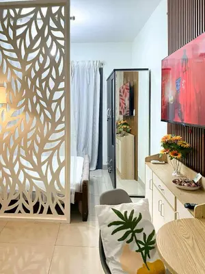 a room with a living room with a partition with a wall at Warm Retreat with Balcony at Shore 2 Residences in Manila