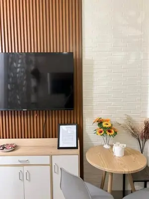 a living room with a table and a flat screen tv at Warm Retreat with Balcony at Shore 2 Residences in Manila