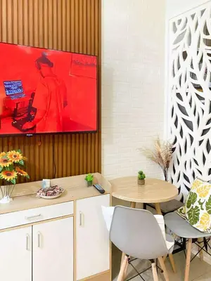 a dining room with a table and a painting on the wall at Warm Retreat with Balcony at Shore 2 Residences in Manila