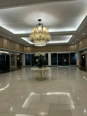 a large lobby with a table and a chandelier at Shell Residences Tower A B in Manila