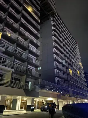 a tall building with a car parked in front of it at Shell Residences Tower A B in Manila