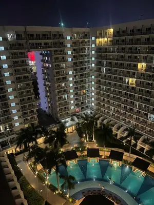 an aerial view of a large building with a pool at Shell Residences Tower A B in Manila