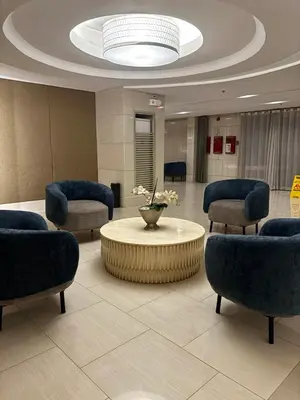 a lobby with a waiting room with chairs and a table at Shell Residences Tower A B in Manila