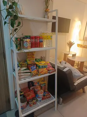 a white shelf filled with food and drinks at Shore residences Yen and Yan Staycation in Manila