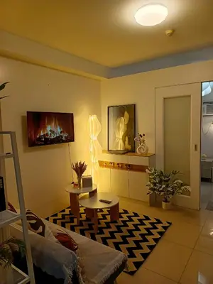 a living room with a couch and a table at Shore residences Yen and Yan Staycation in Manila