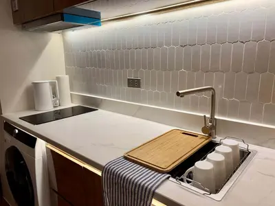 a kitchen with a sink and a counter top with a sink at GRACE RESIDENCES Condo in Manila