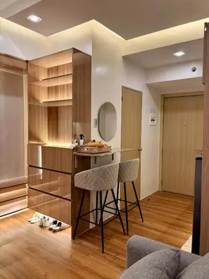 a kitchen with a counter and stools in a room at GRACE RESIDENCES Condo in Manila