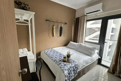 a small bedroom with a bed and a window at 2 BR Fully Furnished Condo in Parañaque with Pool and Parking - Bloom Unit 1133 in Manila