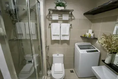 a bathroom with a shower and a toilet and a sink at 2 BR Fully Furnished Condo in Parañaque with Pool and Parking - Bloom Unit 1133 in Manila