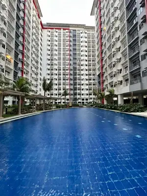 a large swimming pool in front of tall buildings at 2 BR Fully Furnished Condo in Parañaque with Pool and Parking - Bloom Unit 1133 in Manila