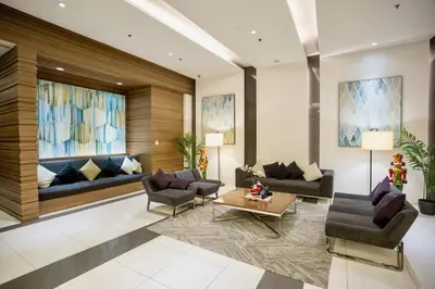 a living room with two couches and a table at Modern Studio with Balcony near Ayala Makati in Manila