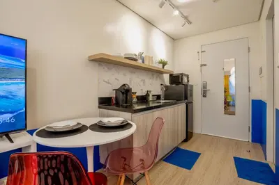a kitchen with a table and chairs in a room at Modern Studio with Balcony near Ayala Makati in Manila