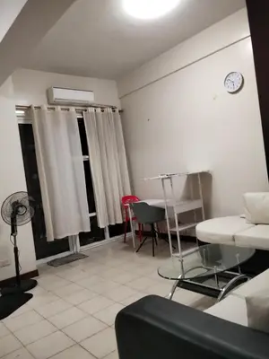 a living room with a couch and a table at Paseo de Roces Condominium in Manila