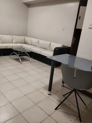 a living room with a couch and a table at Paseo de Roces Condominium in Manila