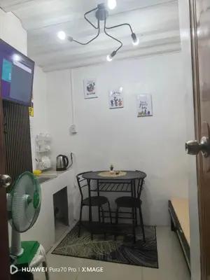 a small table and two chairs in a room at Transient Room for Bypackers in Imus NO CAR PARK in Imus