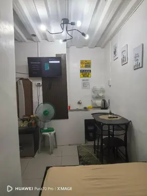 a room with a kitchen with a table and a counter at Transient Room for Bypackers in Imus NO CAR PARK in Imus