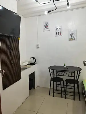 a kitchen with a table and chairs in a room at Transient Room for Bypackers in Imus NO CAR PARK in Imus
