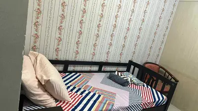a bed with pillows on it in a bedroom at smdc condotel in Manila