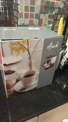 a box with a plant in a vase on a counter at smdc condotel in Manila