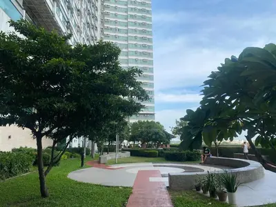 a park in front of a tall building at 2 Bedroom Premium Condominium Beacon Makati in Manila