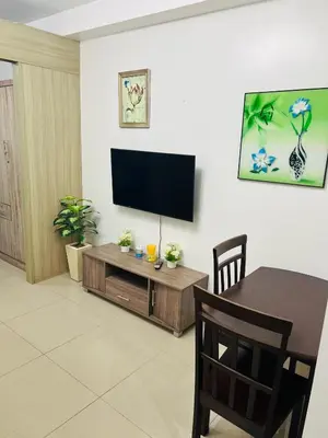a living room with a flat screen tv on a wall at ESY Condotel shore 1-B in Manila