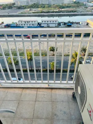 a white railing on a balcony with a view of a street at ESY Condotel shore 1-B in Manila