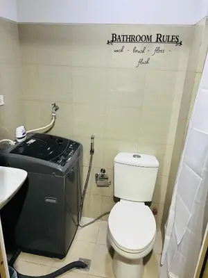 a bathroom with a white toilet and a sink at ESY Condotel shore 1-B in Manila