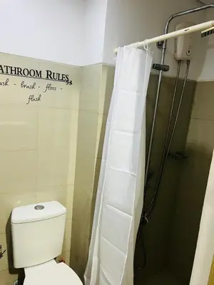 a bathroom with a toilet and a shower at ESY Condotel shore 1-B in Manila