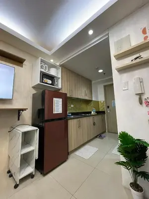 a kitchen with a refrigerator and a microwave at AC Haven in Shore Residences near MOA Pasay City in Manila