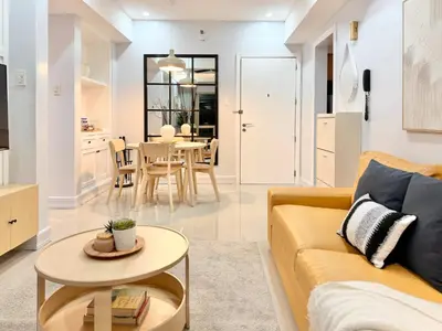 a living room with a couch and a table at Premier 3BR with Fast Internet near High Street BGC in Manila