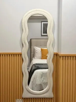 a mirror with a white frame in a bedroom at Premier 3BR with Fast Internet near High Street BGC in Manila