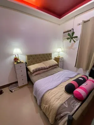 a bedroom with two beds and two night stands at Upzora in Manila