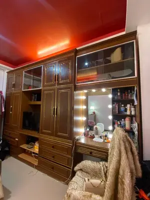 a room with a desk and cabinets and a chair at Upzora in Manila