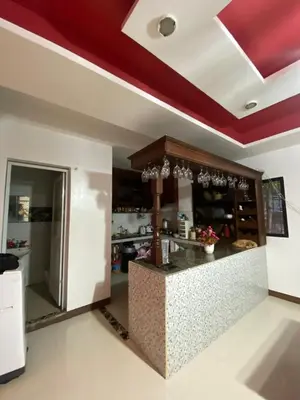 a kitchen with a counter in a room at Upzora in Manila