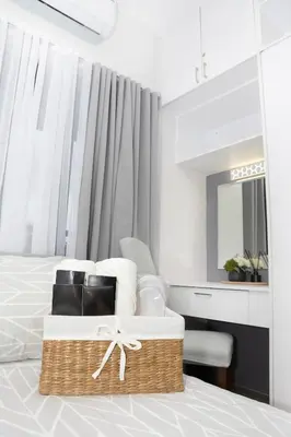a bedroom with a bed with a basket on it at The Place To Be with Balcony and Kitchen Mandaluyong in Manila