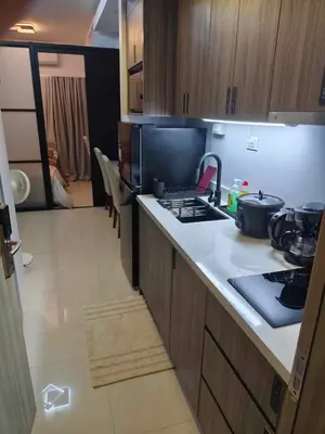 a kitchen with a stove and a counter top at The Place To Be with Balcony and Kitchen Mandaluyong in Manila