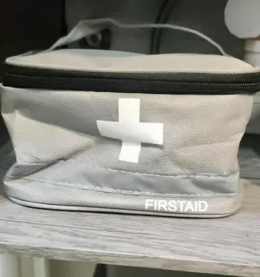 a white first aid bag sitting on a table at The Place To Be with Balcony and Kitchen Mandaluyong in Manila