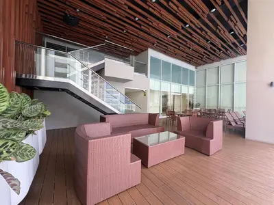 a lobby with pink furniture and a staircase at The Ellis Luxe Suites in Manila