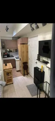 a small kitchen with a table and a counter top at Essel s Comfy Place in Manila