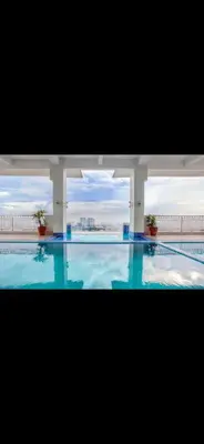 a large swimming pool with a view of a building at Essel s Comfy Place in Manila