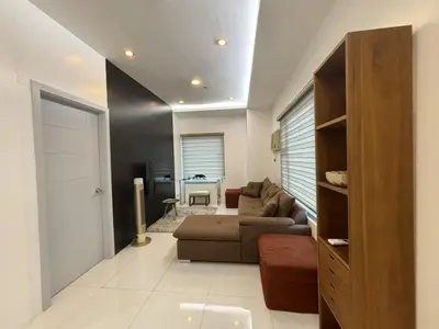a living room with a couch and a table at 8 Adriatico Condominium in Manila