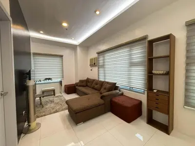 a living room with a couch and a table at 8 Adriatico Condominium in Manila