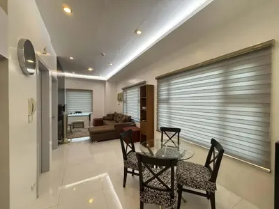a living room with a glass table and chairs at 8 Adriatico Condominium in Manila